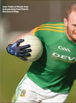  ??  ?? Seán Tobin of Meath tries to break away from Charlie Harrison of Sligo.