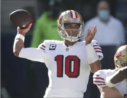  ?? PHOTOS BY SCOTT EKLUND — THE ASSOCIATED PRESS ?? San Francisco 49ers quarterbac­k Jimmy Garoppolo passes against the Seahawks during the first half in Seattle on Nov. 1.