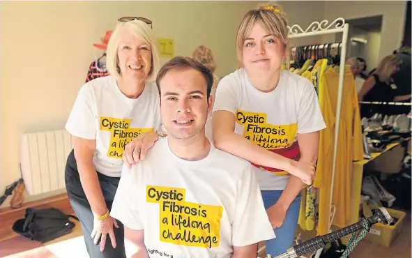 ??  ?? Morag Beckett, left, with her son Greg and volunteer Laura Ross at the opening of a pop-up charity shop for cystic fibrosis.