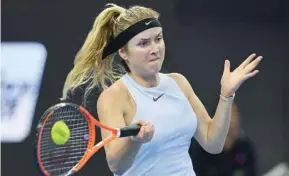  ?? — AFP ?? Caroline Wozniacki of Denmark throws balls to fans as she walks on the court shortly after withdrawin­g from her second round match against Lizette Cabrera of Australia at the WTA tournament in Hong Kong. Elina Svitolina of Ukraine hits a return during...