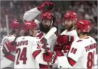  ?? LYNNE SLADKY — THE ASSOCIATED PRESS ?? Carolina defenseman Brent Burns, center, celebrates after scoring the first of his two goals against Florida on Thursday.