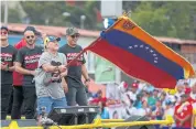  ??  ?? DANCING TO MADURO’S TUNE: Former Argentine soccer player Diego Maradona waves the Venezuelan flag and brands himself a Maduro ‘soldier’.