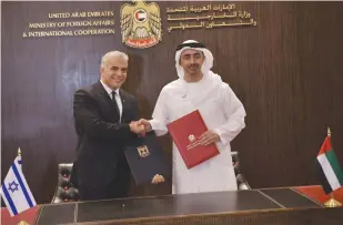  ?? (Shlomi Amsalem/GPO) ?? FOREIGN MINISTER Yair Lapid and UAE Foreign Minister Abdullah bin Zayed al-Nahyan sign cooperatio­n agreements in Abu Dhabi yesterday.