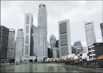  ?? Wong Maye-E The Associated Press ?? Singapore’s financial skyline along the Singapore River. President Donald Trump will meet June 12 with North Korea’s leader Kim Jong Un in Singapore.