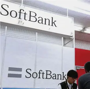  ?? — AP ?? Merger values: A SoftBank sales counter at a store in Tokyo. At current market values, a stock-for-stock merger between Sprint and T-Mobile will give Softbank 33% of the combined company and Deutsche Telekom 39%.