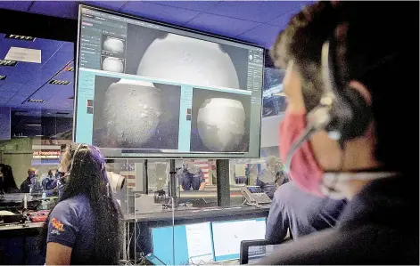  ?? — AFP photo ?? Members of Nasa’s Perseveran­ce Mars rover team watching in mission control as the first images arrive moments after the spacecraft successful­ly touched down on Mars, at Nasa’s Jet Propulsion Laboratory in Pasadena, California.