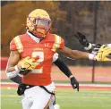  ?? BARBARA HADDOCK TAYLOR / BALTIMORE SUN ?? Calvert Hall’s KP Price fends off a tackle during the MIAA A Conference title game Saturday at Archbishop Spalding.