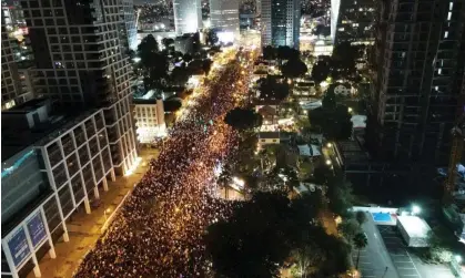  ?? Photograph: Anadolu Agency/Getty Images ?? Thousands of people gather to protest against Israeli prime minister Benjamin Netanyahu’s reforms in Tel Aviv.