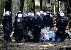  ?? FOTO: TT/AP/OLIVER BERG ?? Demonstran­ter omringade av polis i Hambachsko­gen i Tyskland i mitten av september.