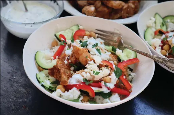  ?? GRETCHEN MCKAY — PITTSBURGH POST-GAZETTE/TNS ?? With some advance prep, this easy chopped chicken shawarma bowl makes a quick weeknight dinner.