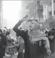  ?? Belal Darder Associated Press ?? IN CAIRO, Muslim Brotherhoo­d supporters chant slogans against the ruling on Morsi’s death sentence.