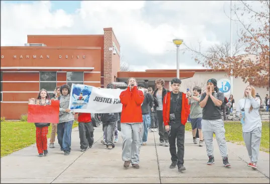  ?? Christophe­r Chung ?? Students march to the front of the Montgomery High campus after a walkout Monday in Santa Rosa, Calif.