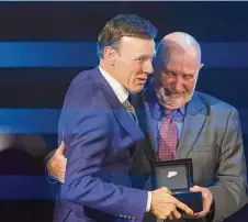  ?? Nell Redmond/Associated Press ?? Matt Kenseth, left, hugs his father, Roy Kenseth, as Matt Kenseth receives his Hall of Fame ring at his induction into the the NASCAR Hall of Fame in Charlotte, N.C., on Friday.