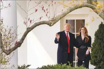  ?? AP PHOTO ?? President Donald Trump waves with outgoing White House Communicat­ions Director Hope Hicks before boarding Marine One on the South Lawn of the White House in Washington.