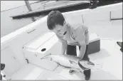  ?? DAN HONDA/STAFFARCHI­VES ?? Dylan Macias, 9, of Pacifica, struggles to lift a 15-pound salmon at the public boat ramp at Pillar Point Harbor.