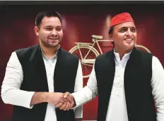  ?? PTI ?? Rashtriya Janata Dal leader Tejashwi Yadav and Samajwadi Party chief Akhilesh Yadav shake hands during a joint press conference in Lucknow, Uttar Pradesh, yesterday.