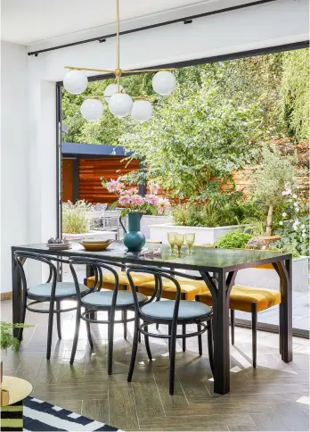  ??  ?? Right Interior designer Jade Maria found vintage dining chairs and covered them in mustard fabric. ‘We also chose a modern, barely there design so they wouldn’t block the view,’ says Claire.