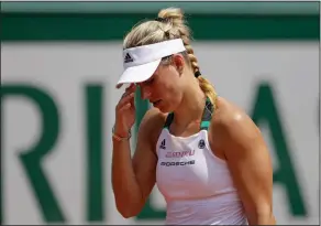  ?? Associated Press ?? Quick exit: Germany's Angelique Kerber reacts after missing a shot when losing in two sets, 2-6, 2-6, against Russia's Ekaterina Makarova at the French Open in Paris, France, Sunday. Angelique Kerber is the first women's No. 1 seed to lose in the...
