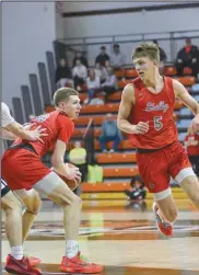  ?? Photo by Brooke Alt ?? Shelby’s Casey Lantz with the ball and Alex Bruskotter on the move in the Stroh Center where the Whippets won the regional championsh­ip over Lutheran West on March 16.