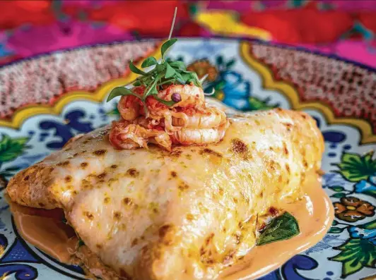  ?? Mark Mulligan / Staff photograph­er ?? Picos’ Enchiladas de Acociles gives the tortilla treatment to sautéed crawfish, topped with chipotle sauce and Chihuahua cheese.