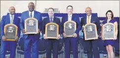  ?? Jim McIsaac / Getty Images ?? Inductees (from left) Harold Baines, Lee Smith, Edgar Martinez, Mike Mussina, Mariano Rivera and Brandy Halladay, wife the late Roy Halladay, pose with their plaques.