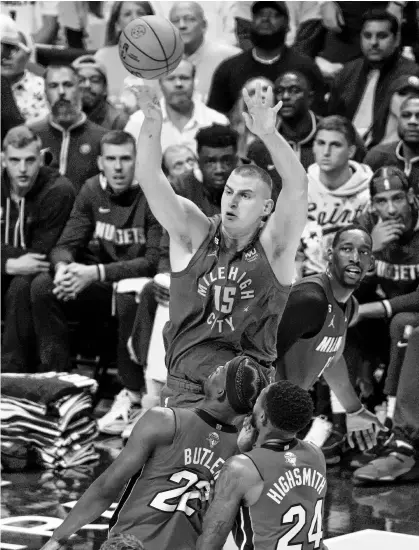  ?? KYLE TERADA ■ USA TODAY SPORTS ?? Denver Nuggets’ Nikola Jokic (15) shoots the ball against the Miami Heat during Game 1 of the 2023 NBA Finals in Denver on Thursday night.