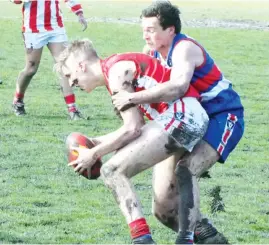  ??  ?? Trafalgar’s Brayde Bosman is wrapped up in a tackle during the Reserves eliminatio­n final against Newborough.