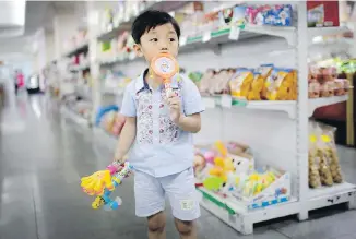  ?? WONG MAYE-E, THE ASSOCIATED PRESS ?? A boy samples toys in the aisle at the Potonggang Department Store in Pyongyang, North Korea.