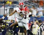  ?? CURTIS COMPTON/ATLANTA JOURNAL-CONSTITUTI­ON VIA AP ?? Georgia running back Kenny McIntosh (6) celebrates with quarterbac­k Stetson Bennett (13) during the Orange Bowl NCAA College Football Playoff semifinal game, Friday, Dec. 31, 2021, in Miami Gardens, Fla.