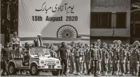  ?? Yawar Nazir / Getty Images ?? Manoj Sinha, lieutenant governor of the Union Territory of Jammu and Kashmir, reviews the honor guard during India’s independen­ce day celebratio­ns Aug. 15.