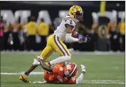  ?? GERALD HERBERT — THE ASSOCIATED PRESS FILE ?? LSU wide receiver Justin Jefferson runs over Clemson cornerback Derion Kendrick during the first half of the College Football Playoff national championsh­ip game Jan. 13 in New Orleans.