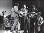  ?? AP FILE PHOTO ?? In this Jan. 20, 1968, photo, folk singer Bob Dylan (center) performs with drummer Levon Helm (left), Rick Danko (second left), and Robbie Robertson of The Band at Carnegie Hall in New York.