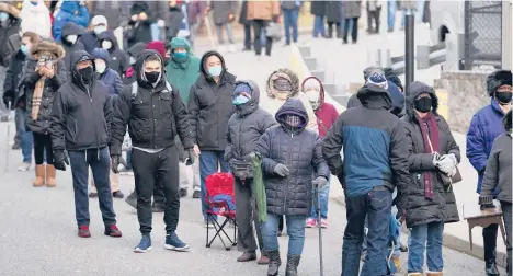  ?? SETH WENIG/AP ?? An analysis by the Associated Press shows Black Americans lagging behind white people in receiving the COVID-19 vaccine. Above, people wait in line to be vaccinated this month in Paterson, New Jersey.