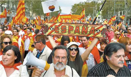  ?? EPA-Yonhap ?? Demonstrat­ors hold Spanish and Catalonian flags as they take part in a rally to mark Spain’s National Day in Barcelona, northeaste­rn Spain, Thursday. The rally held under motto “Catalonia yes, Spain too” was against Catalonian Independen­ce.