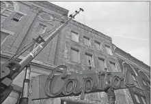  ?? DAY FILE PHOTO ?? The Capitol had been vacant for four years when the New London Redevelopm­ent Agency took down the marquee on Feb. 17, 1978.
