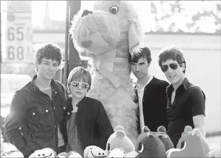  ?? MICHAEL OCHS ARCHIVES/GETTY ?? Jerry Harrison, from left, Tina Weymouth, David Byrne and Chris Frantz of art rock group The Talking Heads get together for a publicity shot with giant stuffed animals in December 1977 in Los Angeles.