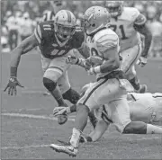  ?? Danny Karnik/Georgia Tech via AP ?? In this photo released by Georgia Tech, Georgia Tech’s Dedrick Mills (26) evades Boston College defensive end Wyatt Ray (11) during the first half of an NCAA college football game, Saturday, Sept. 3, 2016, in Dublin, Ireland. Georgia Tech won 17-14.