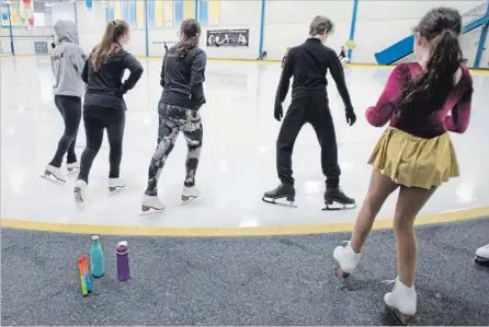  ?? PETER LEE RECORD STAFF ?? Skaters step onto the ice after a flood at the Carolyn Fedy Skating Centre at RIM Park, Waterloo.