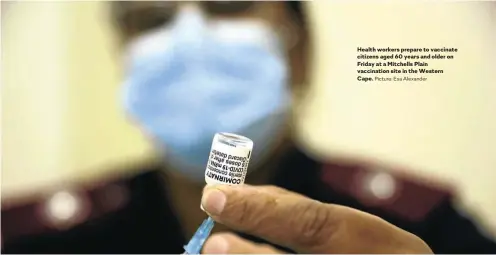  ?? Picture: Esa Alexander ?? Health workers prepare to vaccinate citizens aged 60 years and older on Friday at a Mitchells Plain vaccinatio­n site in the Western Cape.