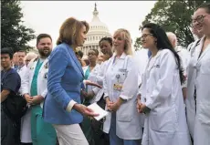  ?? Doug Mills / New York Times ?? Health care workers join House Minority Leader Nancy Pelosi, D-San Francisco, for a rally outside the Capitol in Washington against the Republican­s’ alternativ­e to the Affordable Care Act.