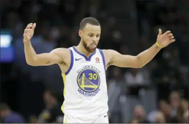  ?? TONY DEJAK — THE ASSOCIATED PRESS ?? Golden State Warriors’ Stephen Curry celebrates in the second half of Game 4 of basketball’s NBA Finals against the Cleveland Cavaliers, Friday in Cleveland.