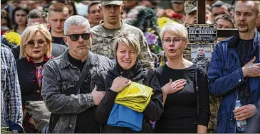  ?? EMILIO MORENATTI/ASSOCIATED PRESS ?? Natalia Pohoreltse­va breaks down at the grave of her son, Melnyk Andriy, 23, a Ukrainian military servicemen who was killed in Kharkiv province. His funeral was Saturday in Lviv, Ukraine.