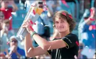  ?? PAUL CHIASSON/THE CANADIAN PRESS VIA AP ?? Alexander Zverev hoists the trophy after defeating Roger Federer in the final at the Montreal Masters on Sunday.
