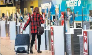  ?? JEFF MCINTOSH THE CANADIAN PRESS FILE PHOTO ?? WestJet is among Canadian airlines hoping that an experiment­al program in Alberta that tests internatio­nal travellers on arrival will be expanded nationally as a way to shorten quarantine times.