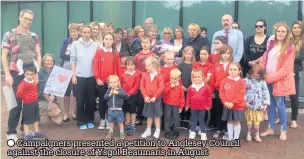  ??  ?? Campaigner­s presented a petition to Anglesey Council against the closure of Ysgol Beaumaris in August