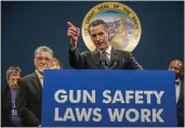  ?? RENÉE C. BYER — THE SACRAMENTO BEE VIA AP ?? Gov. Gavin Newsom answers questions at a press conference to push for the passing of Senate Bill 2in Sacramento on Wednesday. Newsom wants to limit where people can carry concealed guns.