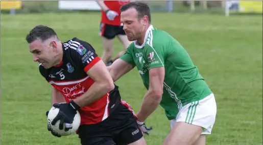  ??  ?? John Harvey of Drumcliffe/Rosses Point in action with St Molaise Gaels’ Eoin McHugh. Pic: Donal Hackett.