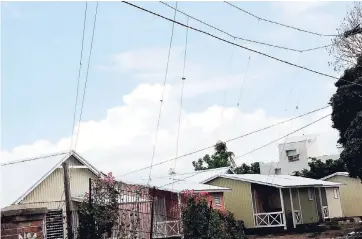  ?? NORMAN GRINDLEY/CHIEF PHOTOGRAPH­ER ?? In this April 15, 2010 photograph is seen a web of illegal electricit­y connection­s from JPS high-tension wires in Allman Town, central Kingston.