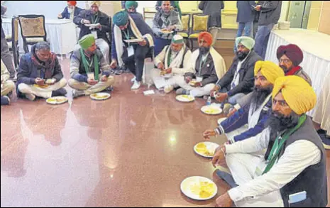  ?? ANI ?? Farmer leaders, including BKU leader Rakesh Tikait, having food at the Vigyan Bhavan during the 9th round of meeting with the central government in New Delhi on Friday.