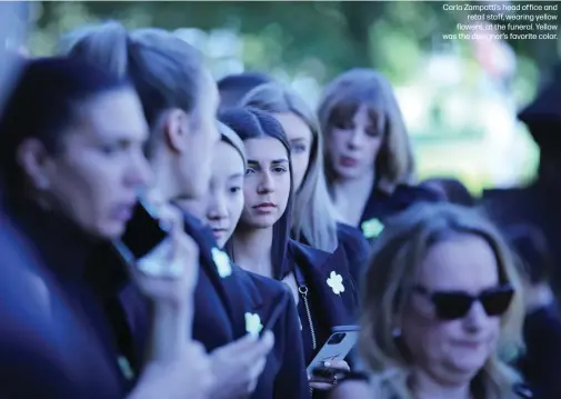  ??  ?? Carla Zampatti’s head office and retail staff, wearing yellow flowers, at the funeral. Yellow was the designer’s favorite color.